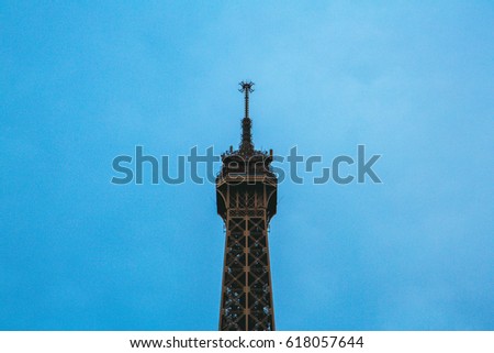 Beautiful Eiffel tower top part spire from below in Paris, France.