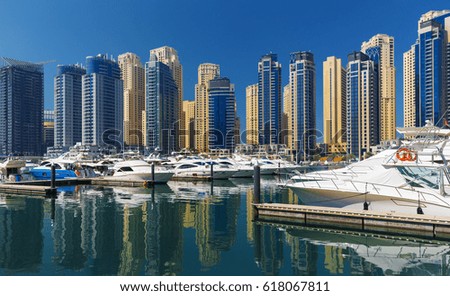 Dubai Marina with promenade and water canal with luxury boats before the sunset,Dubai,United Arab Emirates