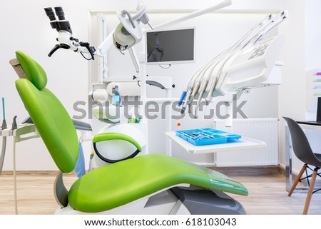 Modern dental office with green chair and professional tools