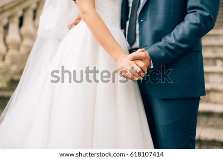 The newlyweds hold hands. Couple holding hands. Wedding in Montenegro.