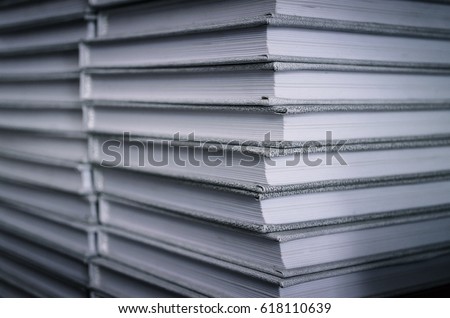Stack of gray books on a bookshelf in the library. Front view. Education concept.