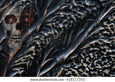 A black, brown and golden background made of metal and a skull
