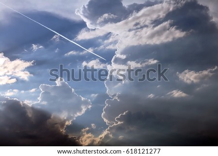 A dark thundercloud in the blue sky