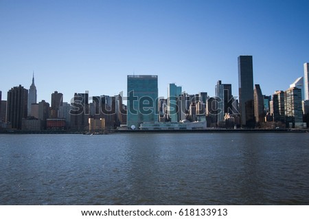 Buildings over river with blue sky, New York