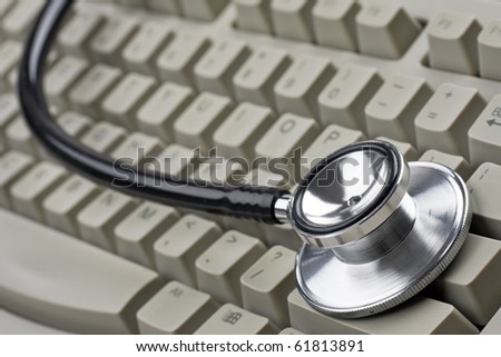 Doctor's stethoscope on computer keyboard.
