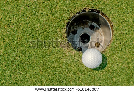 Golf ball very close to the hole