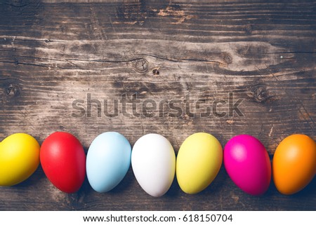 Easter Eggs on old boards. Painted eggs. Old board background. Easter ideas. Easter eggs. Space for text. Image in trendy toning.