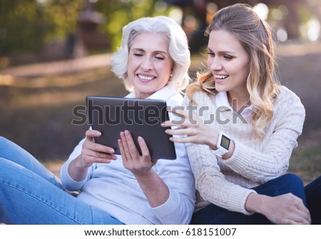 Active woman enjoying picnic with old mother in the park Royalty-Free Stock Photo #618151007