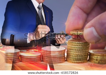 Double exposure of Euro Coin stacks on table, businessman working with tablet, light trails on the street and urban at dusk, night as business, investment,currency and exchange rate concept.