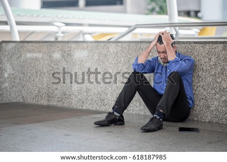 Side view of a sad man with a hand on the head sitting in the office sad business loser concept