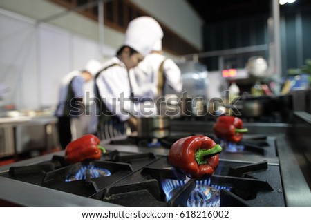  Chef in hotel or restaurant kitchen cooking, he is burning Bell peppers.
