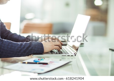 financial managers working on laptop with financial data at the workplace in a modern office