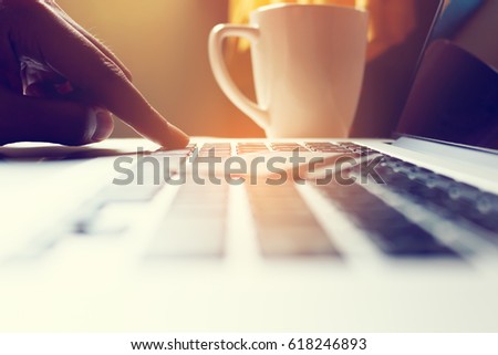 Close up of hand man typing on keyboard laptop with shopping online.