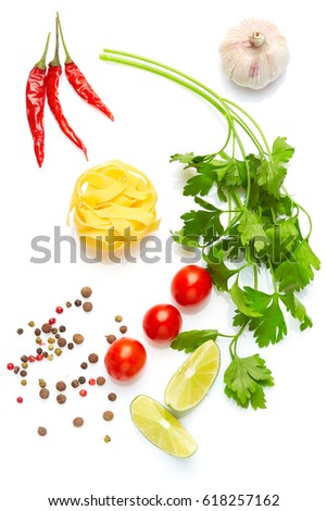 Mediterranean food and drink healthy diet: Fresh vegetables spices and Italian herbs. Top view. Isolated on white. Cherry tomatoes parsley lime pasta garlic chili peppers and peppers Royalty-Free Stock Photo #618257162