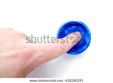 Finger and Blue color paint in a jar isolated on white background