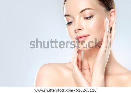 Beautiful Young Woman with Clean Fresh Skin look away  .Girl beauty face care. Facial  treatment   . Cosmetology , beauty  and spa . Royalty-Free Stock Photo #618265118