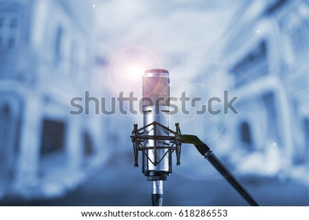 Condenser microphone with blue bokeh background.High quality microphone standing on  karaoke stage ready for joyful christmas party