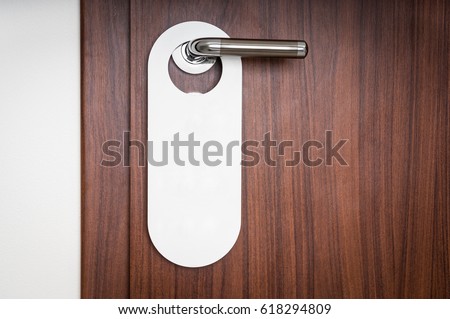 Door of hotel room with empty sign please do not disturb Royalty-Free Stock Photo #618294809