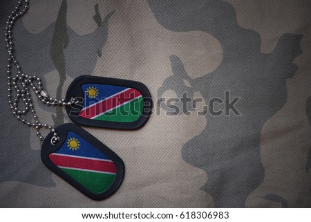 army blank, dog tag with flag of namibia on the khaki texture background. military concept