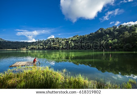 Beautiful volcanic lake of Linow Lake in North Sulawesi, Indonesia with fisherman Royalty-Free Stock Photo #618319802