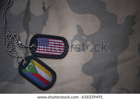 army blank, dog tag with flag of united states of america and comoros on the khaki texture background. military concept