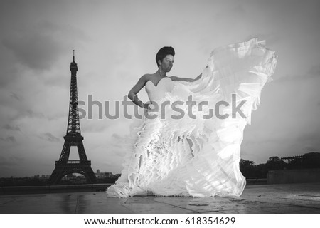 An attractive young bride posing for wedding pictures, showing her beautiful stylish white dress