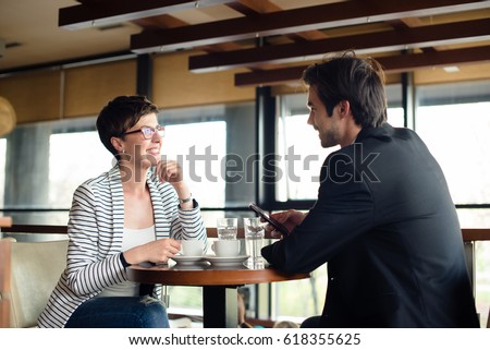 Business meeting at cafe, man and woman