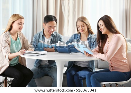 People sitting at table in book club