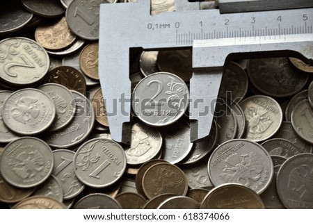 coin is clamped in a caliper on the coins background
