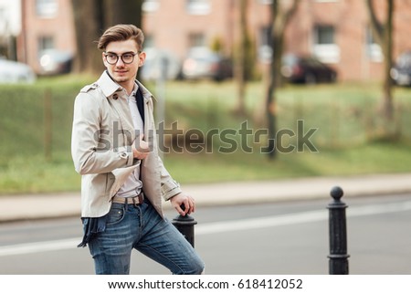 Fashionable man walking on the street with blur background