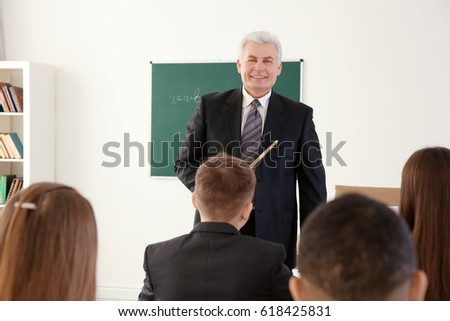 Pupils listening to teacher in classroom