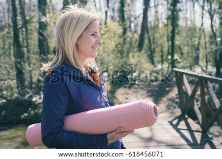 Sporty woman with yoga mat
