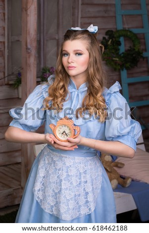 Alice holding a clock in her hands