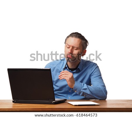 Handsome business man working on an office table with a laptop