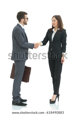 Image of two young managers shaking hands at meeting