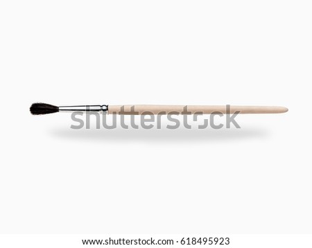 Wooden paint brush hovering, isolated on white background
