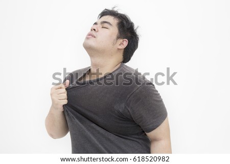 Asian man tired and sweat full shirt, Asian man take a deep breath to get oxygen, Asian man playing sports, on white background