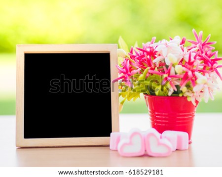 Poster mock up template with flower bouquet, marshmallow in the shape of heart and books over green background