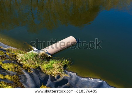 Pipe from underground ending in a leachate pond. Location Ronneby, Sweden.
