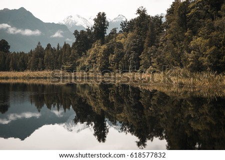 Mountain and trees reflection in lake Matheson, New Zealand