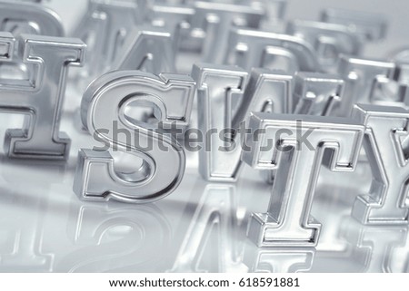 Silver alphabet letters close-up on a white background