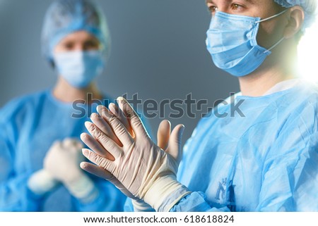 Concentrated doctors dressed in surgical uniform Royalty-Free Stock Photo #618618824