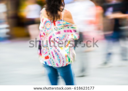Young woman walking blurred image. Londoners at warm summer day. UK