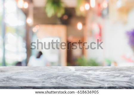 Stone table top and blurred restaurant interior background - can used for display or montage your products.
