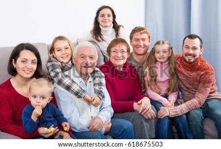 Family members making family photo during a reunion party 