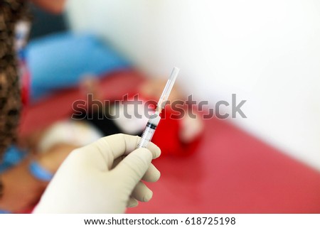 Syringe, medical injection Liquid drug or narcotic in hand, palm or fingers. Medicine plastic vaccination.Medical staff prepares needle