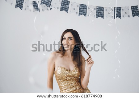 Young beautiful girl in a gold dress. Toning.