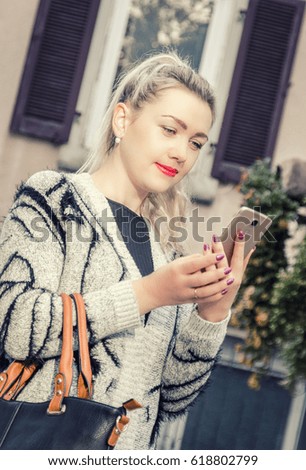 Stylish girl looks in smartphone
