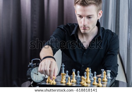 business competition concept with man playing chess game board