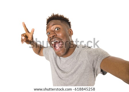 young afro american man smiling happy taking selfie self portrait picture with mobile phone looking excited having fun posing cool isolated in white background in communication technology concept